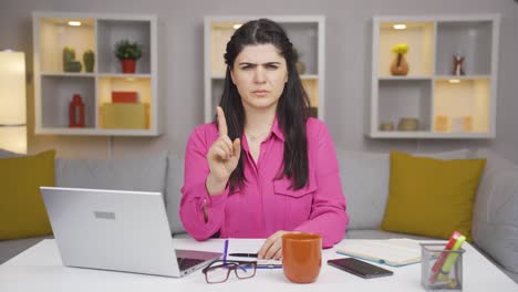 Home-office-worker-woman-looking-at-camera-with-a-stern-angry-warning.